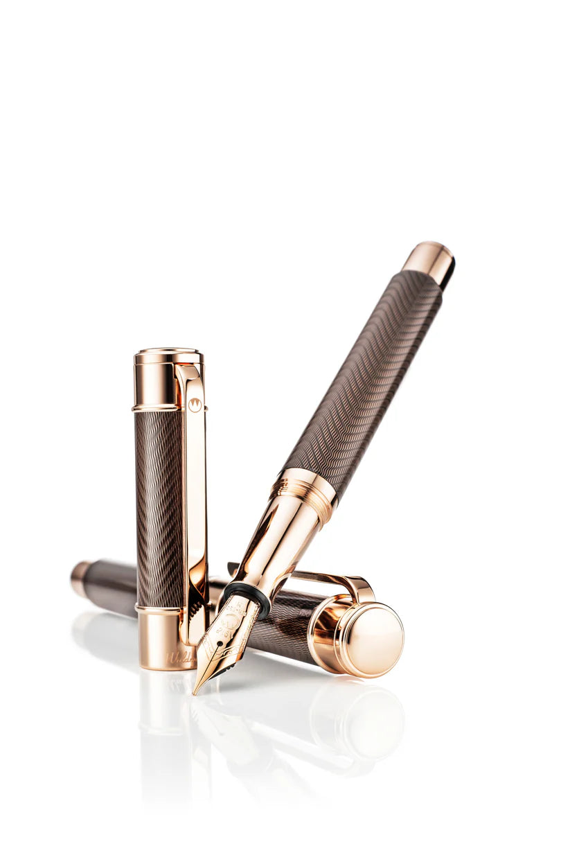 Luxury pen with rose gold accents on a white background